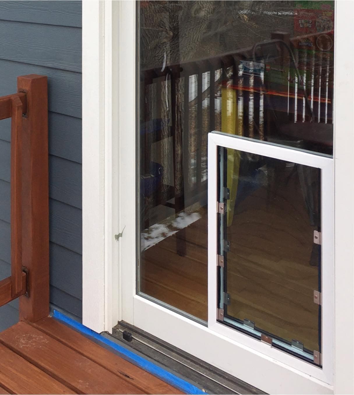 Installed pet door in a glass patio door